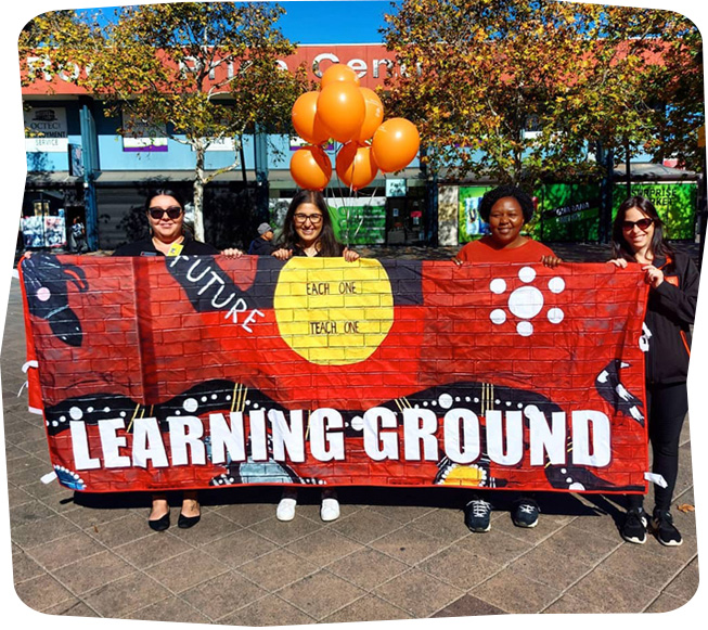 Holding the Learning Ground banner